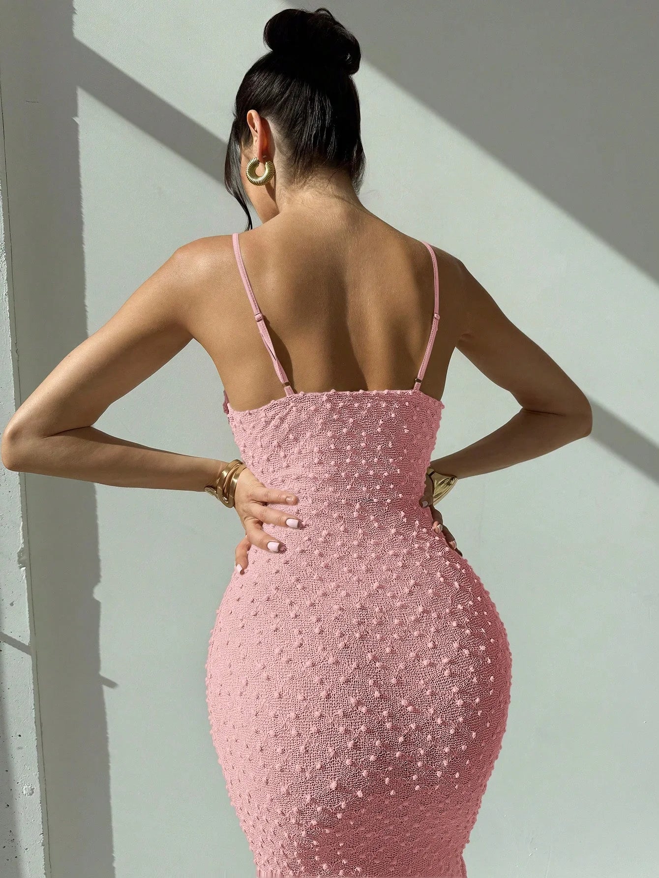 Elegant and romantic long dress for ladies with thin shoulder straps, a cinched waist and a slim figure, made of textured fabric